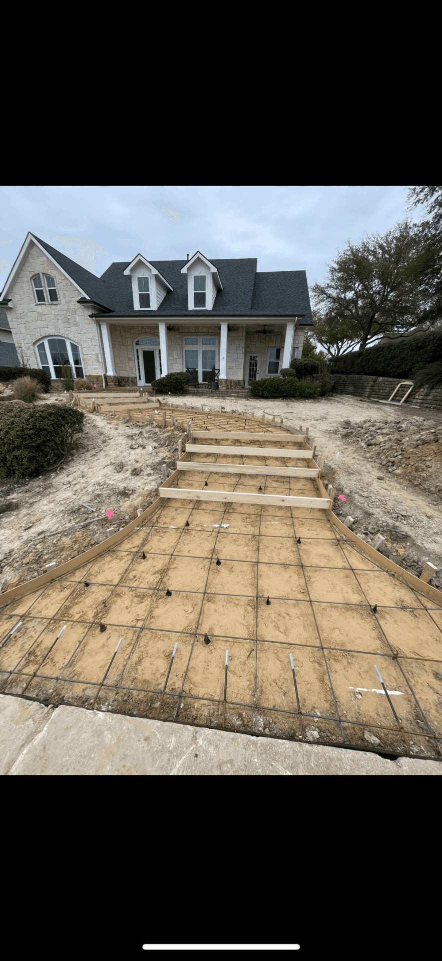 Concrete walkway forms and rebar prepared before a hardscape pour