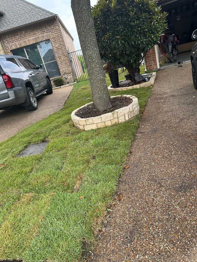Front yard project photo from Nextdoor showing stone borders and sod work